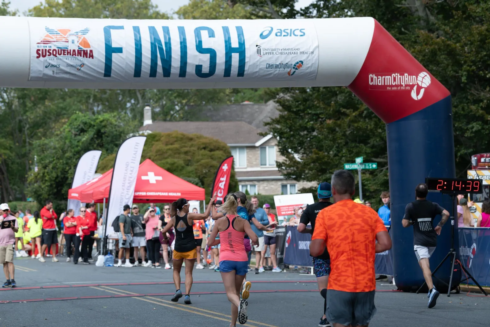 Runners crossing the finish line at the Susquehanna River Running Festival.
