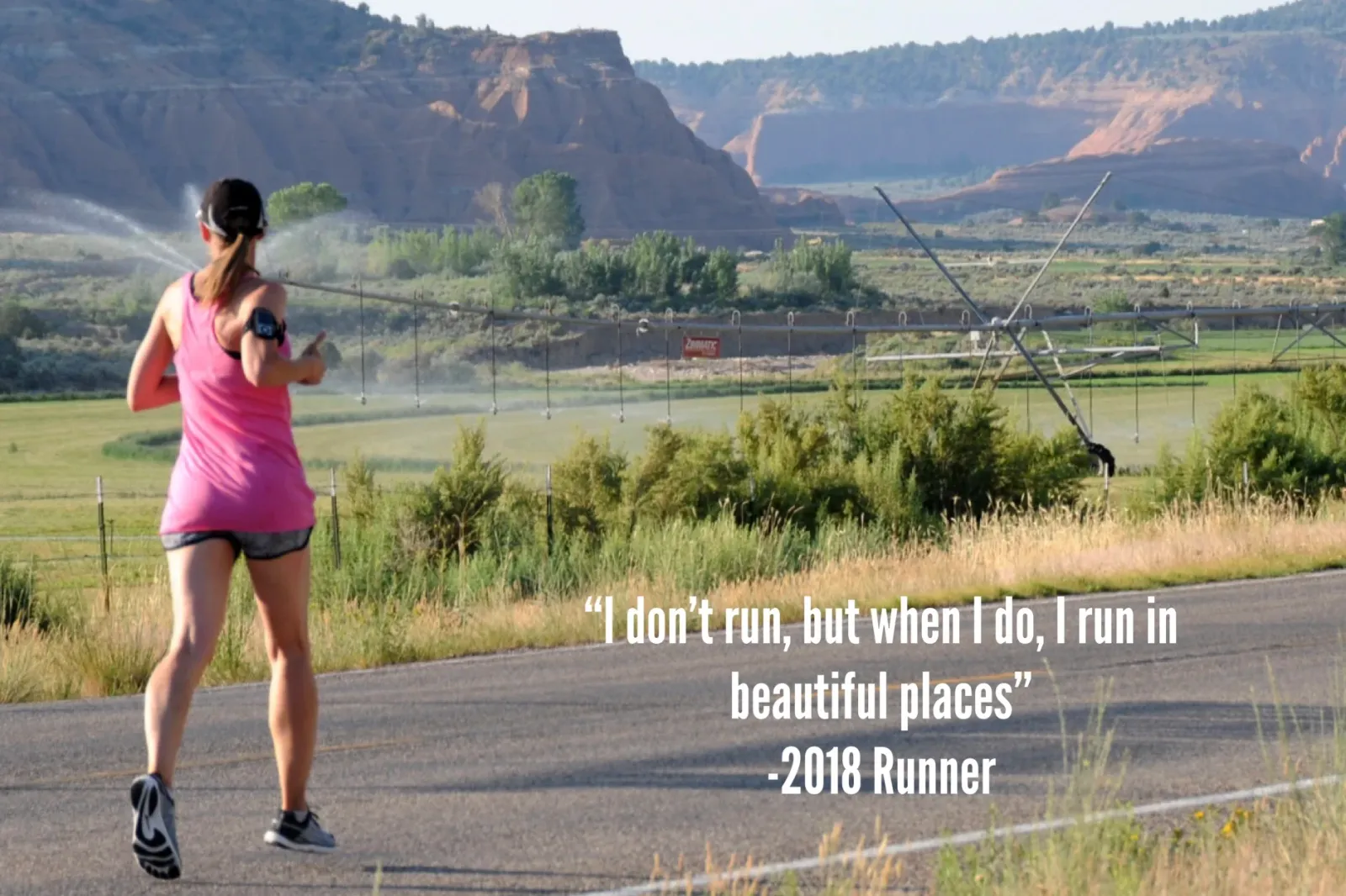 A female runner in a pink tank top runs on a road with a scenic canyon landscape in the background, with a quote overlaid on the image.