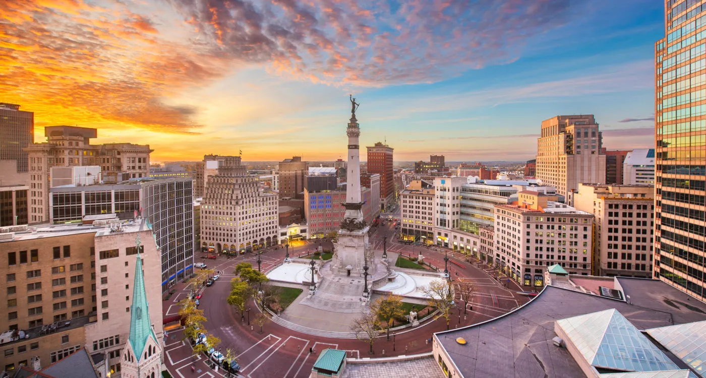 Sunrise over Monument Circle in Indianapolis, with the Soldiers and Sailors Monument prominently featured.