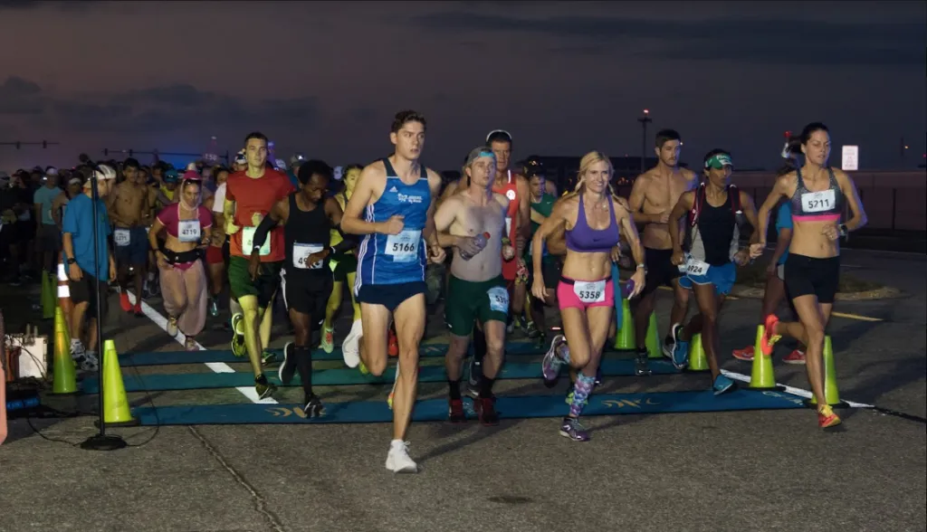 Runners starting the Cocoa Beach Half Marathon at dawn.