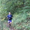 A runner on a wooded trail.