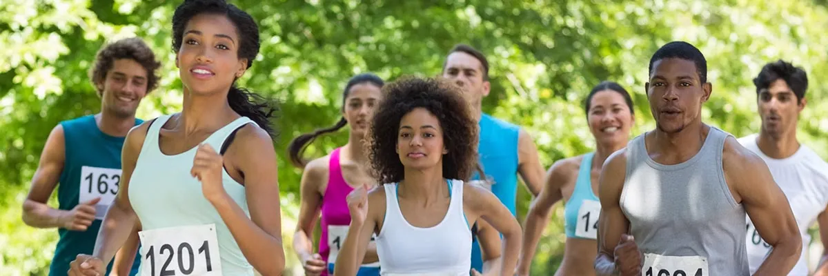 A diverse group of runners in a race, with focus on the front runners.