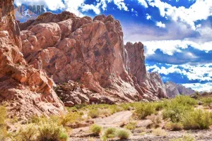 Scenic view of rocky desert landscape with a dirt path, likely part of the race course.