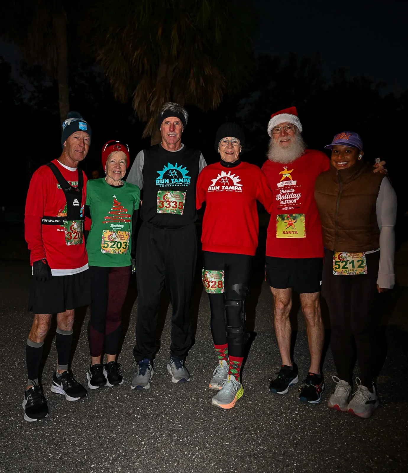 A group of six runners, including one dressed as Santa, pose for a photo at the Florida Holiday Distance Classic.
