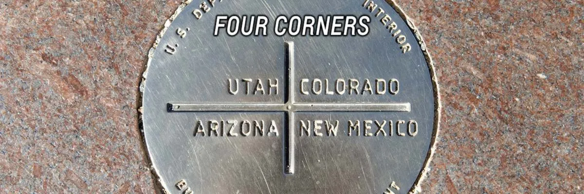 The Four Corners Monument marker showing Utah, Colorado, Arizona, and New Mexico.