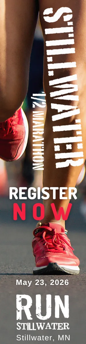 Close-up of a runner's legs and feet in red shoes, with the text "STILLWATER" and "REGISTER NOW" overlaid, along with the date and location.