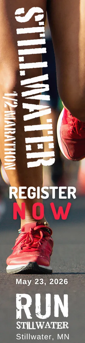 Close-up of a runner's legs and feet in red shoes, with text overlay promoting registration for the Stillwater Half Marathon on May 23, 2026.