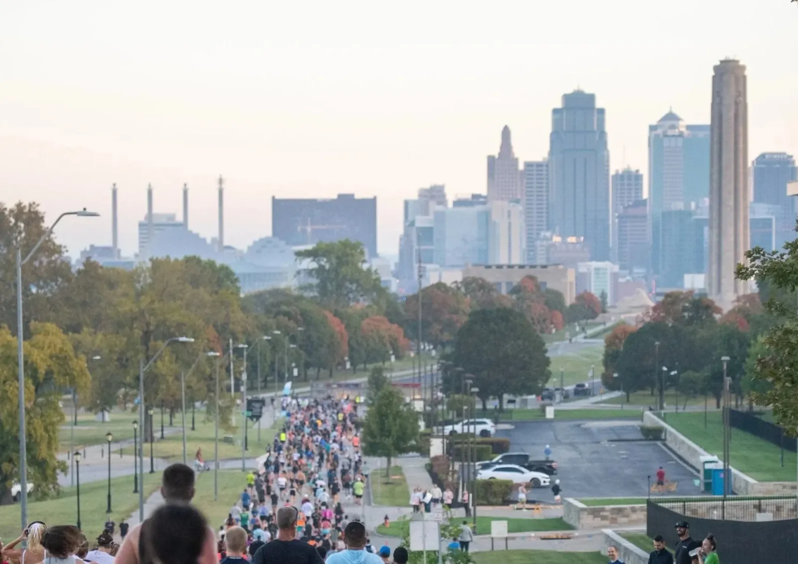 Runners participating in a race with the Kansas City skyline in the background.