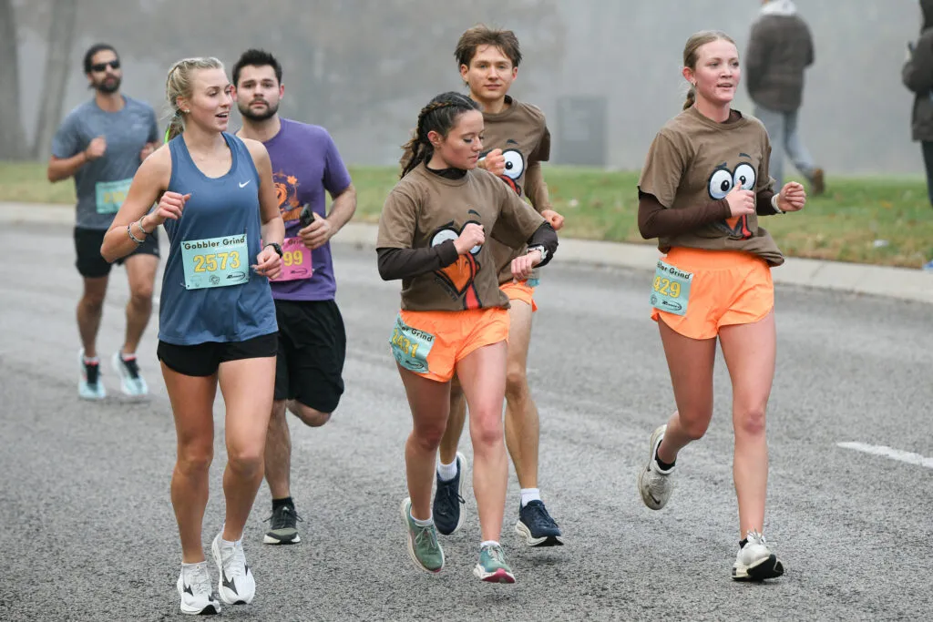 Runners participating in the Gobbler Grind race, with bib numbers visible.