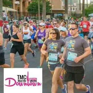 A group of runners participating in a race, with some wearing 5K t-shirts and bibs.