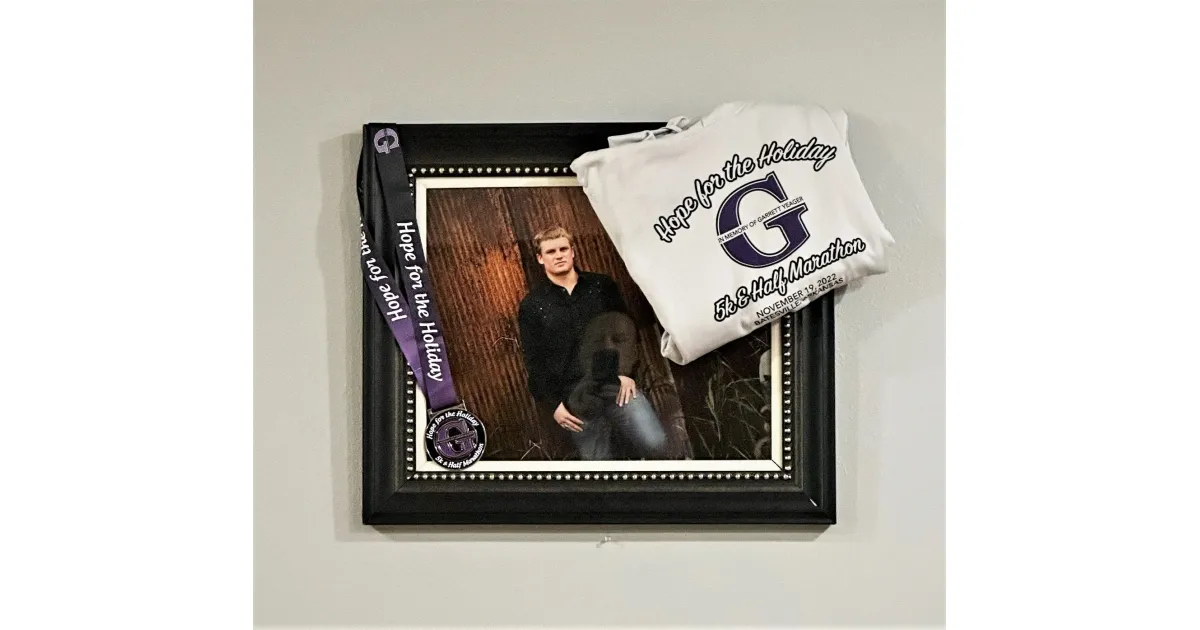Framed photo of a runner with a race medal and a 'Hope for the Holiday' t-shirt.