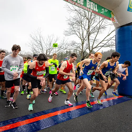 Runners poised at the start line of the Jingle Bell Half Marathon & 5K.