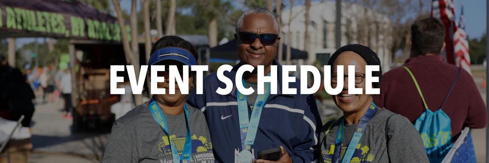 Three people smiling and wearing race medals, with the text "EVENT SCHEDULE" overlaid on the image.