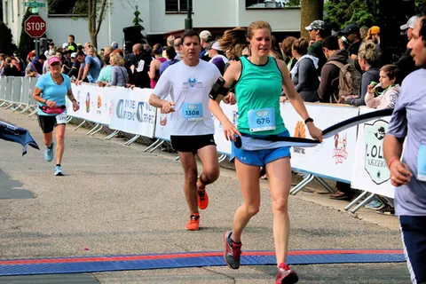 Runners crossing the finish line at the Lola's Lake Waconia Half Marathon.