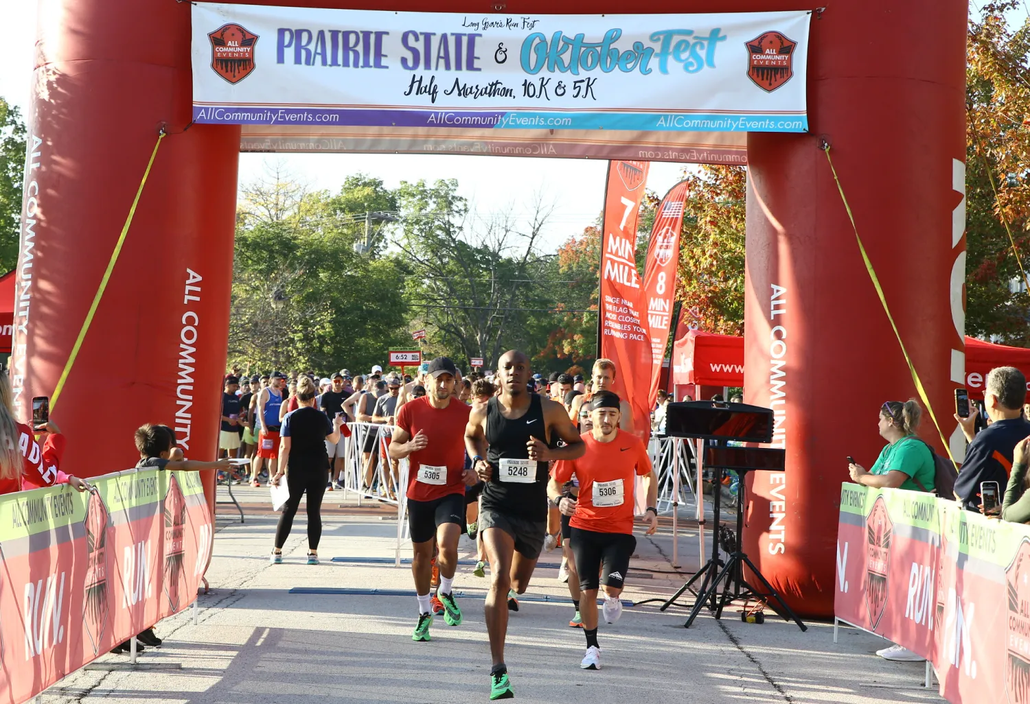 Runners crossing the start line at the Prairie State & Oktoberfest Half Marathon, 10K & 5K.