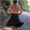 Runner in a kilt with a large circular tattoo on their back, running on a wooded trail.