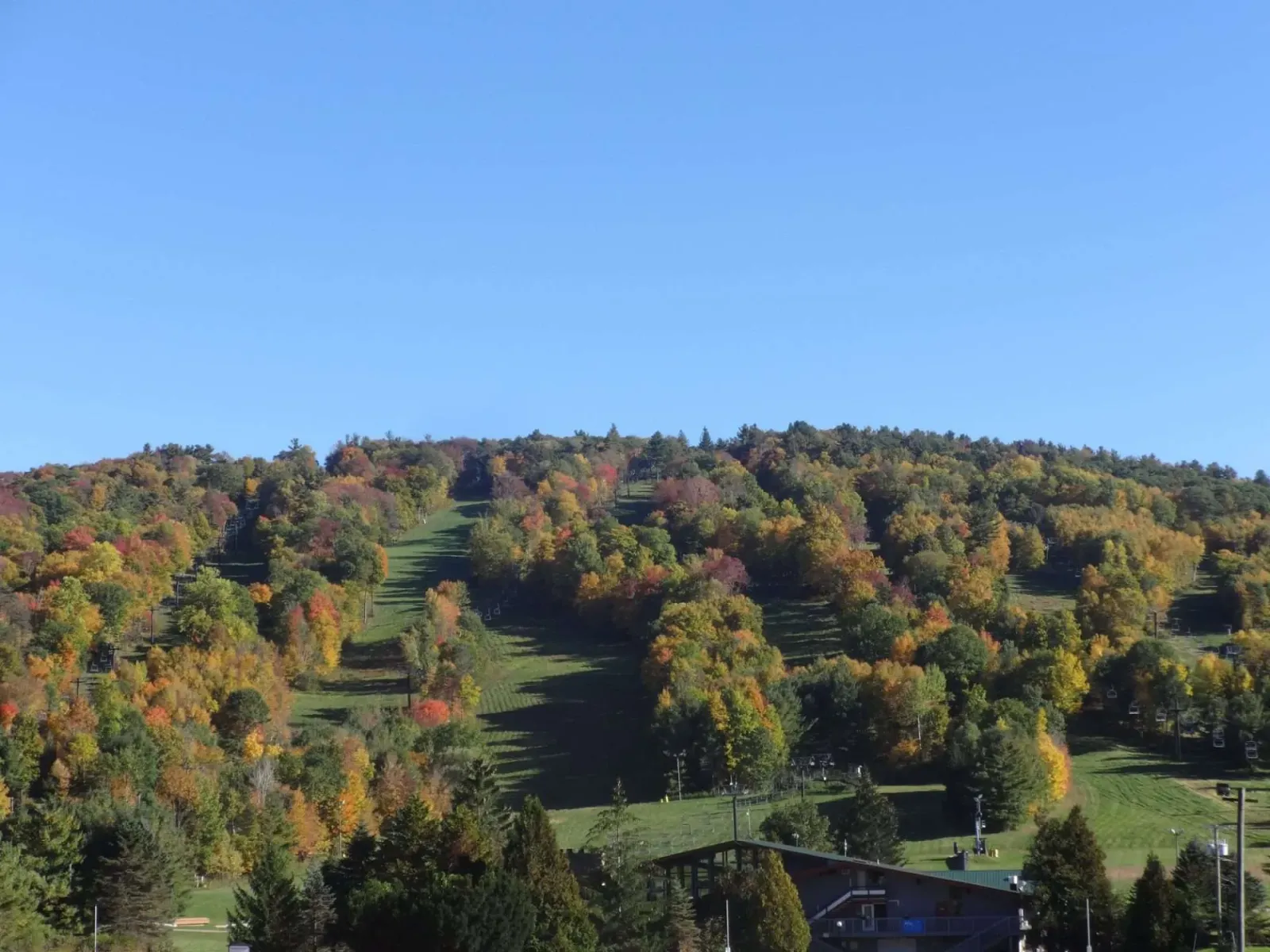 A scenic view of Mohawk Mountain with colorful autumn foliage and ski slopes.
