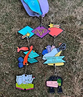 Collection of New Year's Double race medals, including designs featuring an elephant, a lucky number 7, and gemstones.