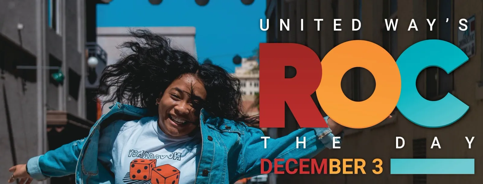 A young woman with her arms outstretched and hair flying, smiling joyfully, with the 'ROC THE DAY DECEMBER 3' logo overlaid.