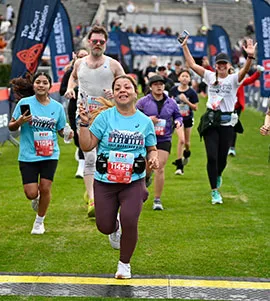 Runners celebrating as they cross the finish line at the Rose Bowl Half Marathon & 5K.