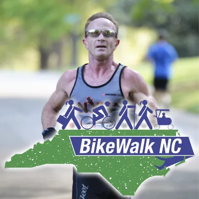 A male runner in sunglasses and a racing tank top runs towards the camera, with a graphic overlay of the state of North Carolina and the text 'BikeWalk NC'.