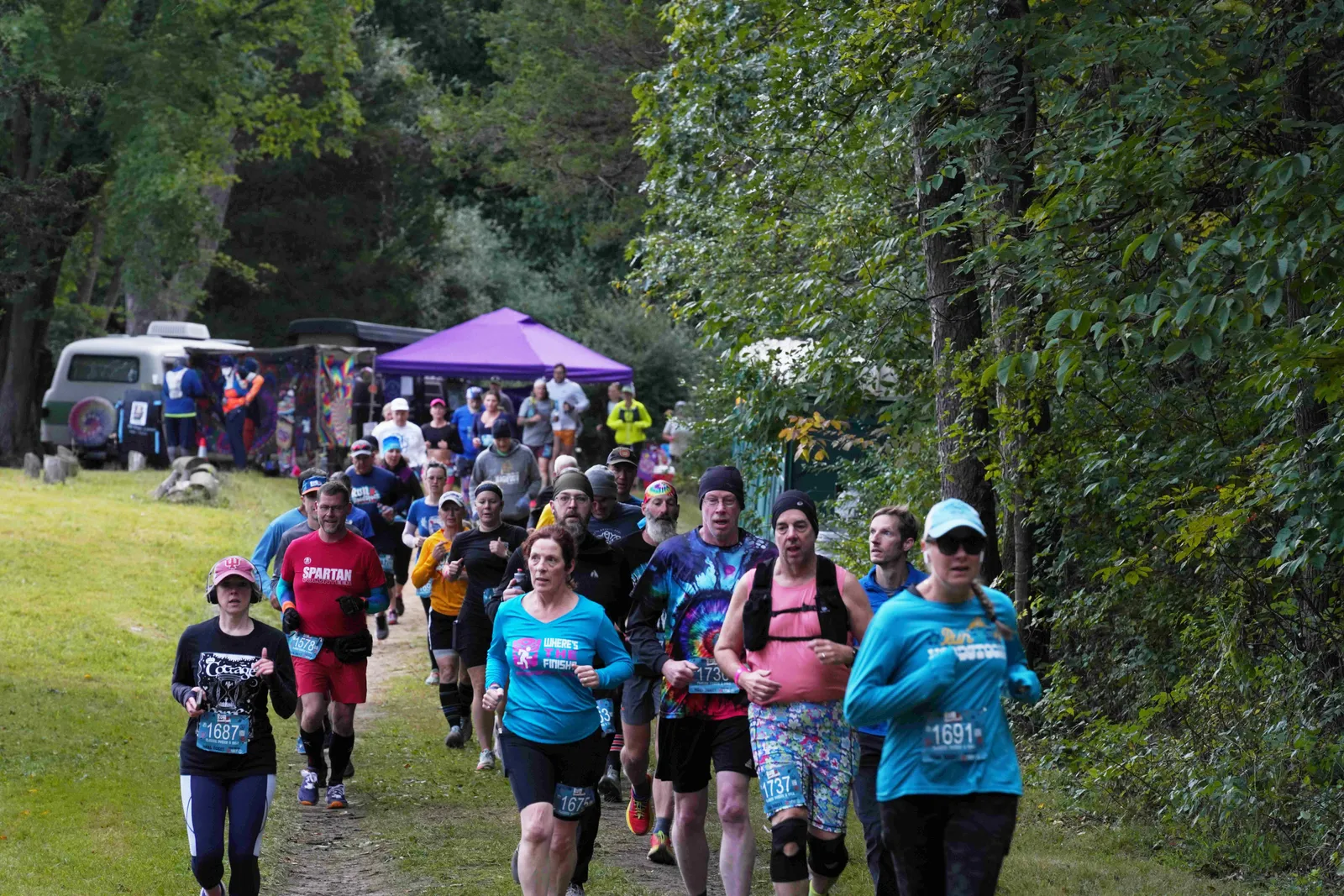 A group of runners on a wooded trail during the Woodstock Half Marathon.