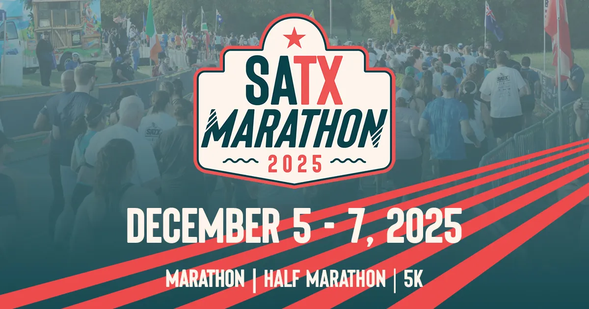 A crowd of runners at the start line of the SATX Marathon 2025, with race branding and event details visible.