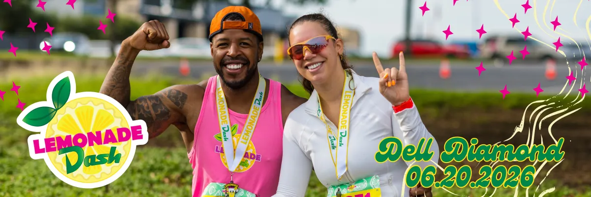 A man flexing his bicep and a woman making a rock-on hand gesture, both smiling and wearing medals from the Lemonade Dash race.