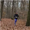 A runner on a wooded trail in the fall.