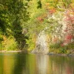 Scenic view of a river with autumn foliage on the banks.