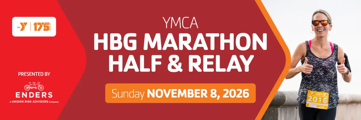 A smiling female runner in sunglasses gives two thumbs up while running, with the race title 'YMCA HBG MARATHON HALF & RELAY' and date 'Sunday NOVEMBER 8, 2026' overlaid on the image.